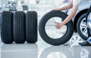 A person stacking a fresh set of tires at a service center near Orangeburg, South Carolina.