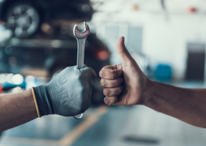 A car repair person giving a thumbs up in a service center near Indianapolis, Indiana