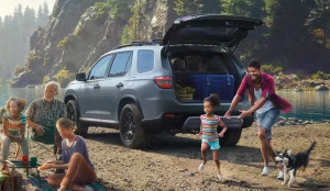 A family playing at a beach near their 2024 Honda Pilot near Indianapolis, Indiana