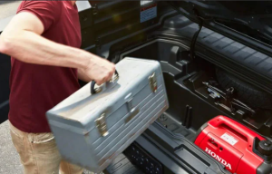 A person putting their toolbox into a 2024 Honda Ridgeline near Indianapolis, Indiana