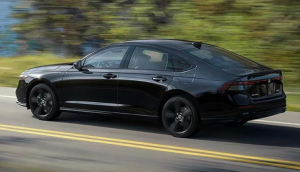 A black 2024 Honda Accord Sedan driving down a wooded road near Indianapolis, Indiana