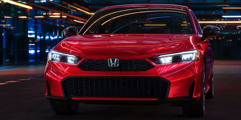 2025 Honda Civic flaunting on the roads of Indianapolis reflecting the bright city lights