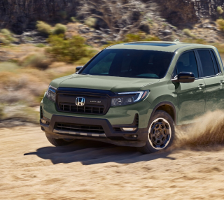 Green Honda Ridgeline TrailSport kicking up dust on a desert trail