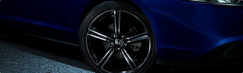Close-up of a black machined alloy wheel on a blue Honda Accord